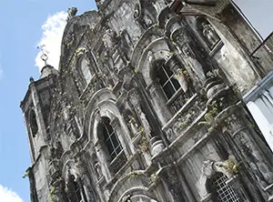 Alte Kirche in Quezon City, Philippinen, im Barockstil mit sichtbaren Anzeichen von Verwitterung.