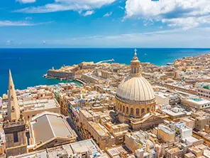 Blick auf Valletta auf Malta mit Kuppel der Karmelitenkirche, historischen Gebäuden und Meer im Hintergrund